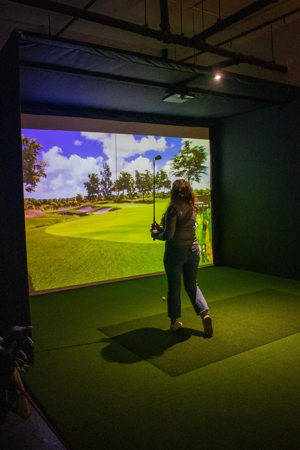 Members playing a round together in one of the five Trackman bays