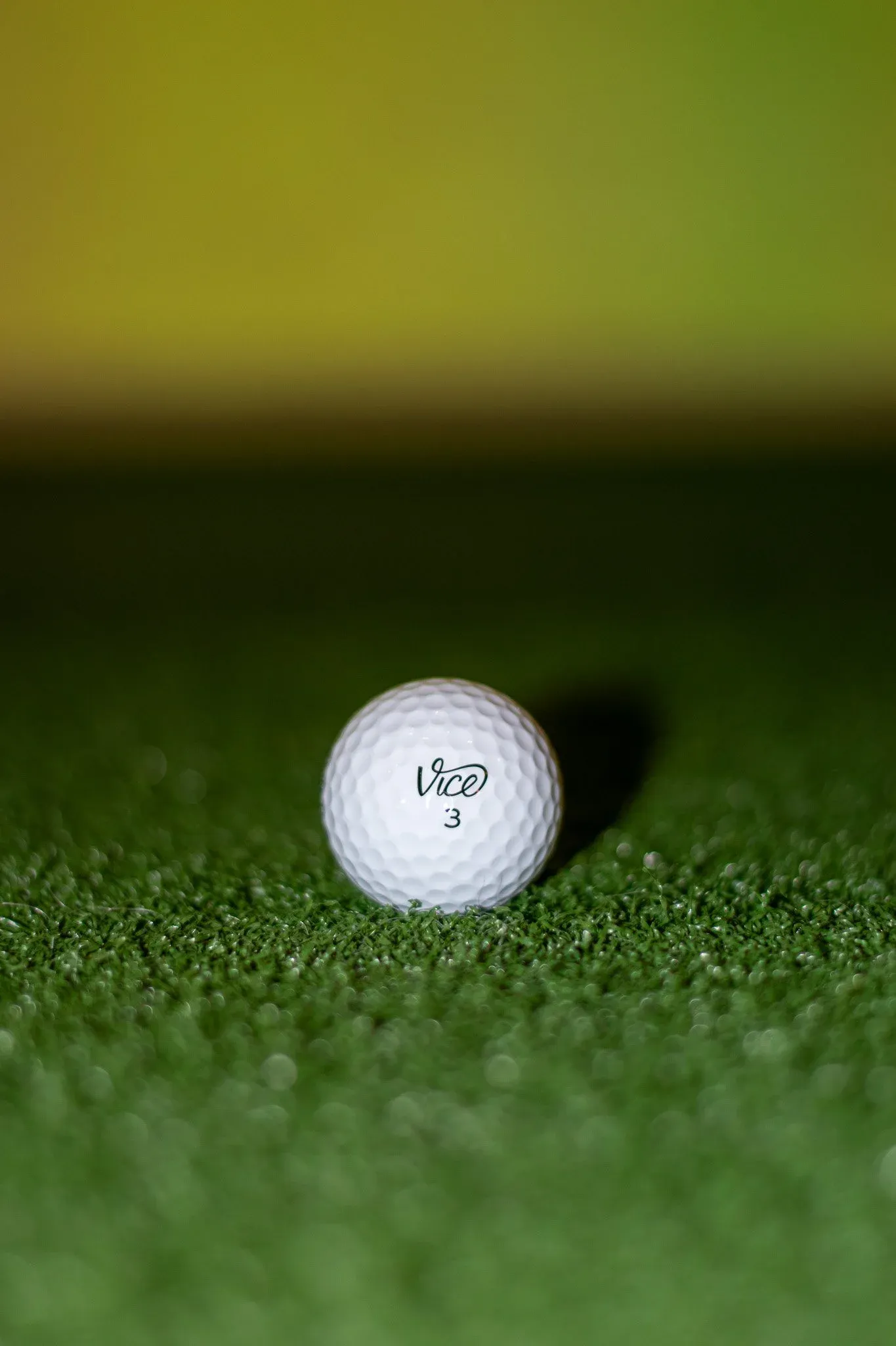 Vice golf ball on the mat in a simulator bay at SGC Wandsworth Common
